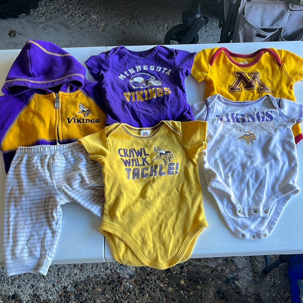 Bundle of Minnesota Vikings football baby clothes.